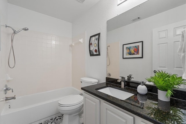 full bathroom with vanity, tiled shower / bath combo, toilet, and tile patterned flooring