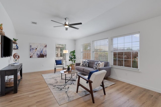 living room with light wood-type flooring and ceiling fan