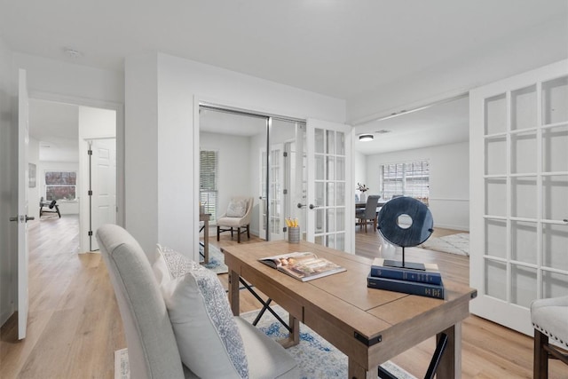 home office featuring french doors and light hardwood / wood-style floors