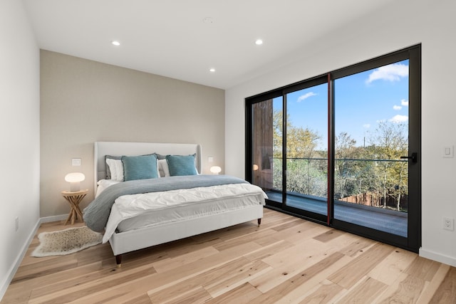 bedroom with access to outside and light hardwood / wood-style floors