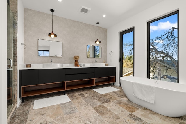 bathroom with vanity and separate shower and tub