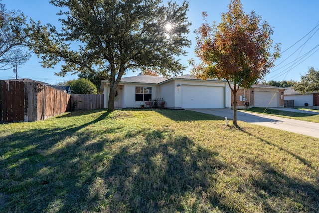 ranch-style house featuring a front yard and a garage