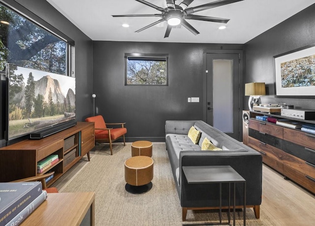 living room featuring ceiling fan and hardwood / wood-style floors