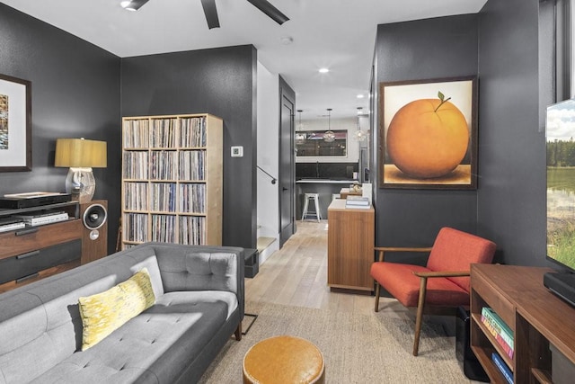 living room with ceiling fan and light hardwood / wood-style floors