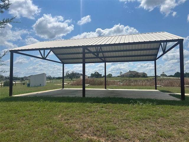 exterior space with a carport and a lawn