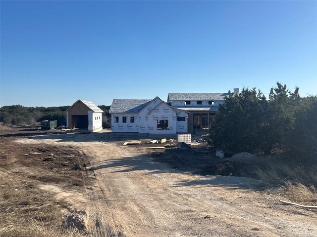 property under construction with a garage and an outbuilding