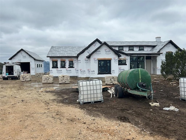 back of house featuring a garage