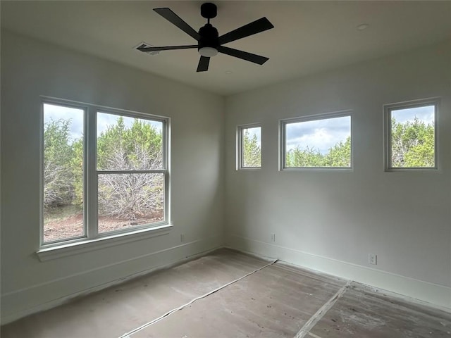 spare room featuring baseboards, ceiling fan, and visible vents