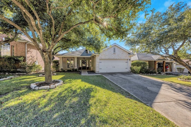 view of front of property featuring a garage and a front lawn