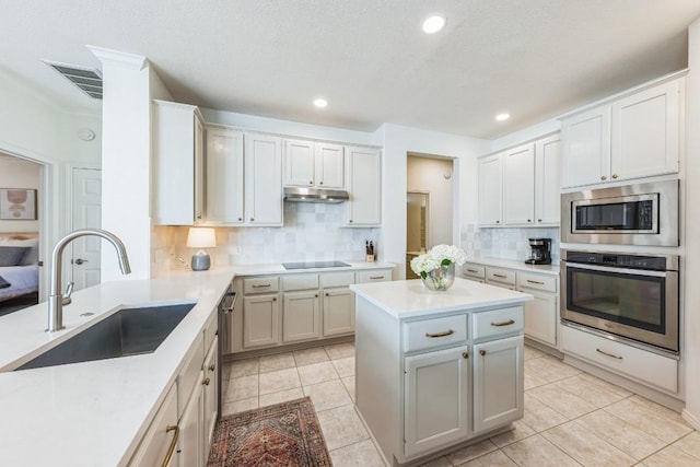 kitchen featuring light tile patterned flooring, backsplash, stainless steel appliances, and sink