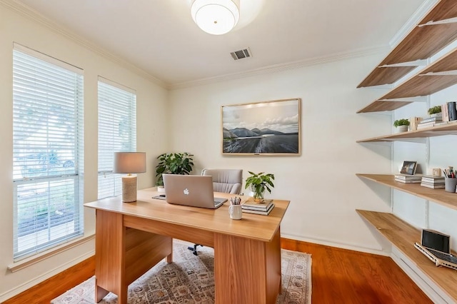 office area featuring hardwood / wood-style floors, ornamental molding, and a wealth of natural light