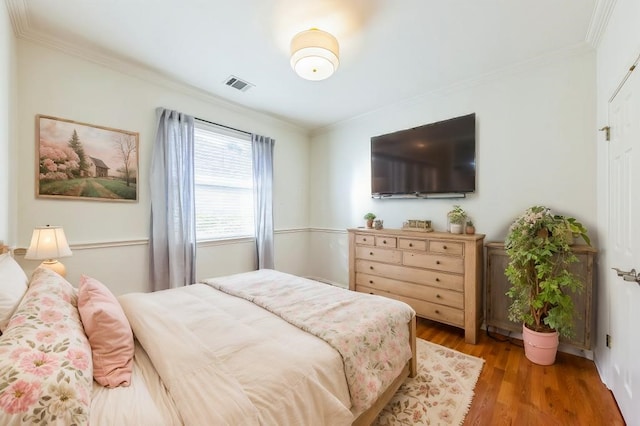 bedroom featuring crown molding and hardwood / wood-style floors