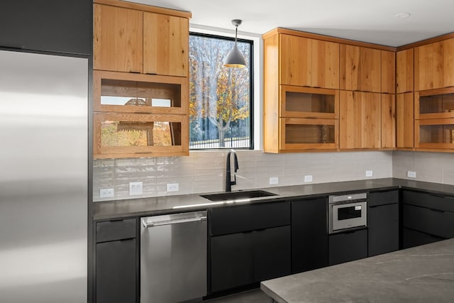 kitchen featuring decorative light fixtures, tasteful backsplash, stainless steel dishwasher, sink, and wall oven