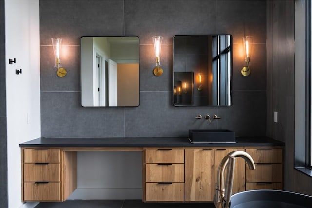 bathroom featuring vanity and decorative backsplash