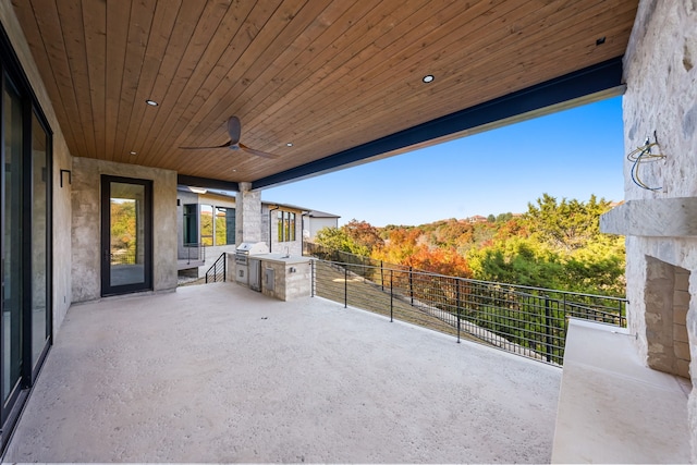 view of patio / terrace with grilling area, ceiling fan, and an outdoor kitchen