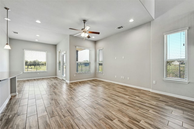 empty room with light wood-type flooring and ceiling fan