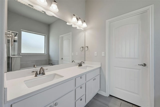 bathroom featuring vanity and a tub to relax in