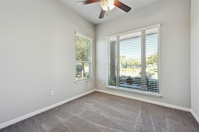 carpeted empty room featuring a wealth of natural light and ceiling fan