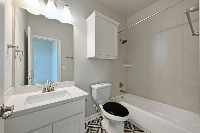 full bathroom with vanity, tile patterned floors, tiled shower / bath combo, and toilet