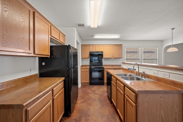 kitchen featuring a textured ceiling, sink, hanging light fixtures, and black appliances