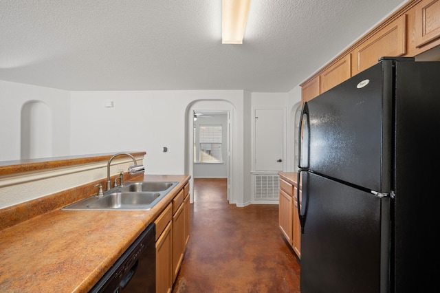 kitchen with sink, a textured ceiling, and black appliances