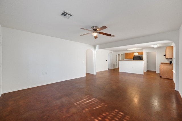 unfurnished living room with ceiling fan