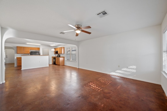 unfurnished living room featuring ceiling fan