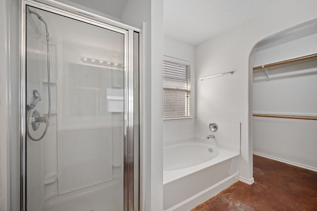 bathroom featuring plus walk in shower and concrete floors