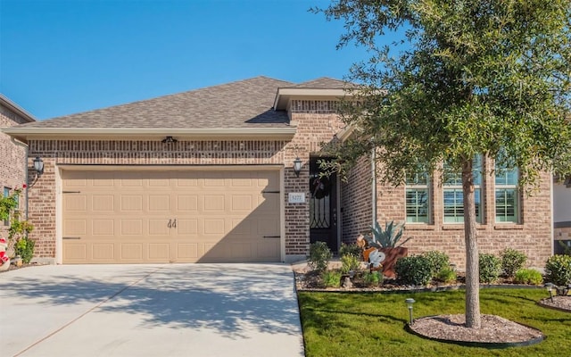 view of front of home with a garage and a front lawn