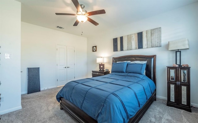 carpeted bedroom with a closet and ceiling fan