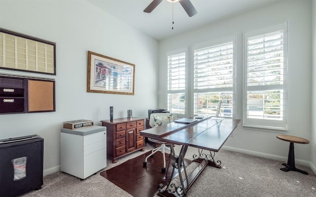 office space featuring plenty of natural light, light colored carpet, and ceiling fan