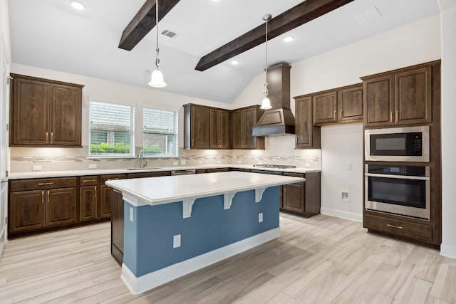 kitchen with appliances with stainless steel finishes, backsplash, custom exhaust hood, pendant lighting, and lofted ceiling with beams