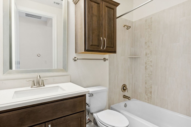 full bathroom with vanity, toilet, and tiled shower / bath