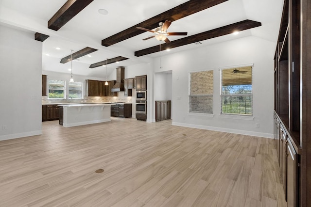 5152 Cornetto Blfs, Round Rock, TX 78665 - unfurnished living room featuring ceiling fan, beam ceiling, light wood-style flooring, baseboards, and a sink