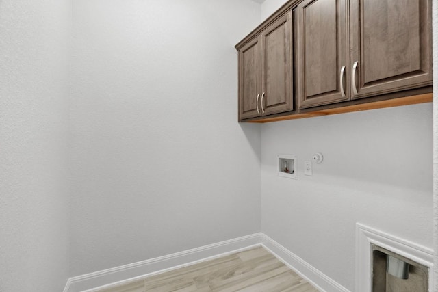 5152 Cornetto Blfs, Round Rock, TX 78665 - laundry room with cabinet space, hookup for a washing machine, hookup for a gas dryer, baseboards, and light wood-style flooring