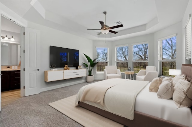 5152 Cornetto Blfs, Round Rock, TX 78665 - bedroom with a tray ceiling, multiple windows, light colored carpet, and ensuite bathroom