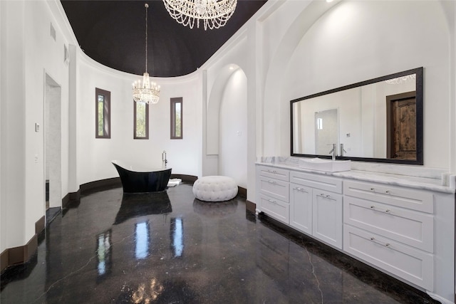 bathroom with crown molding, a towering ceiling, a chandelier, a bathtub, and vanity