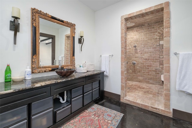 bathroom featuring a shower, vanity, and concrete floors