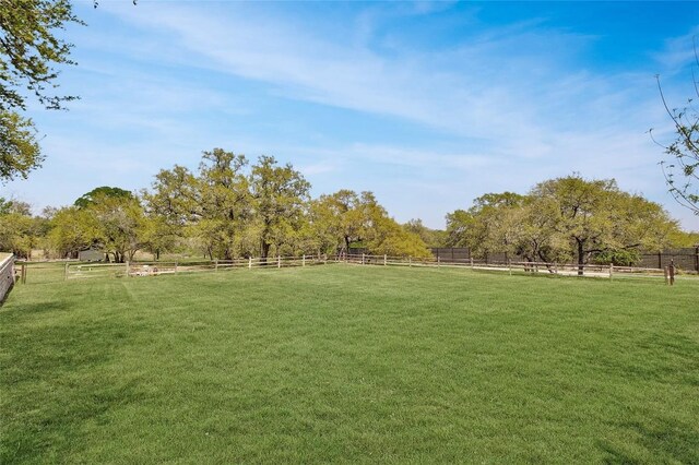 view of community with a yard and a rural view