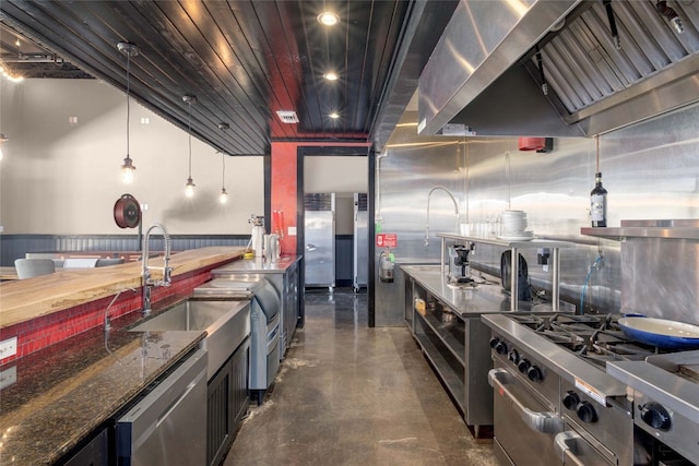 kitchen with wall chimney exhaust hood, wooden ceiling, stainless steel appliances, butcher block countertops, and pendant lighting