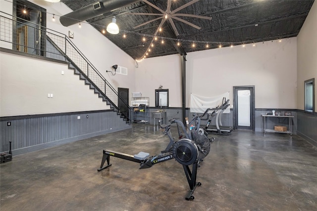 exercise area featuring a high ceiling