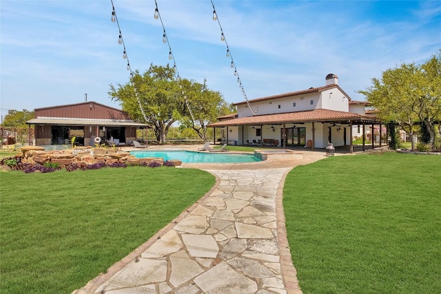 view of swimming pool featuring a lawn and a patio