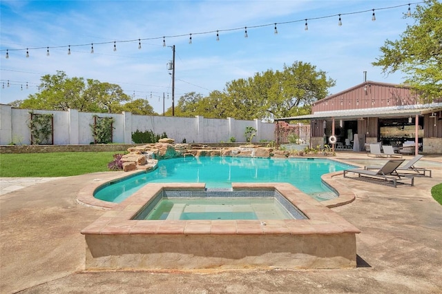 view of swimming pool featuring a patio area and an in ground hot tub