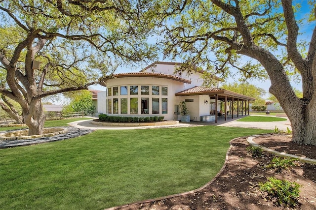 rear view of property with a yard