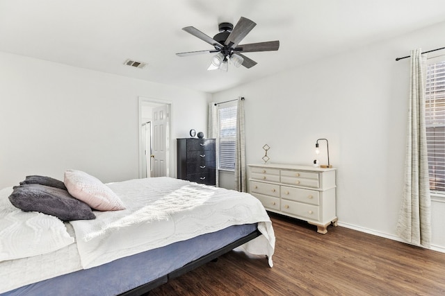 bedroom with dark hardwood / wood-style floors and ceiling fan