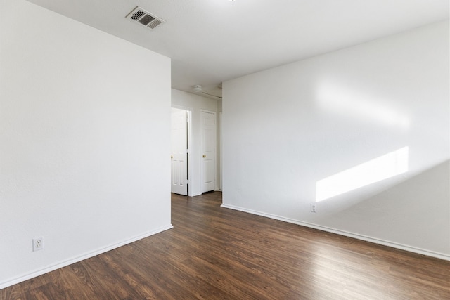 unfurnished room featuring dark hardwood / wood-style flooring