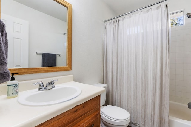 full bathroom featuring shower / bathtub combination with curtain, vanity, and toilet