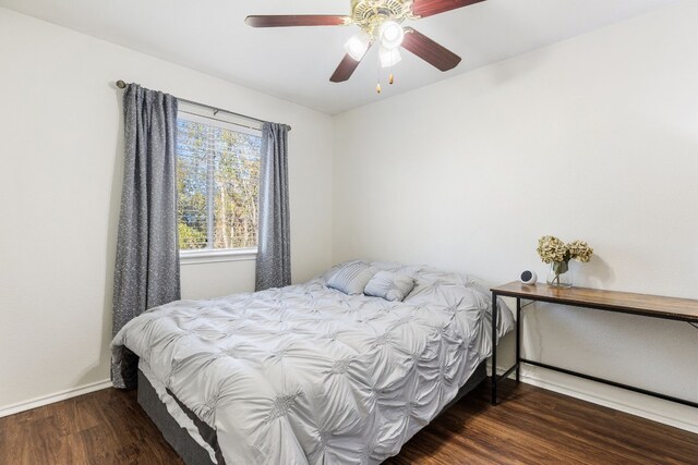 bedroom featuring dark hardwood / wood-style flooring and ceiling fan