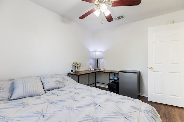 bedroom with ceiling fan and dark hardwood / wood-style flooring