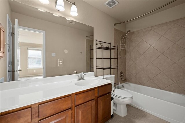 full bathroom with tile patterned floors, vanity, toilet, and tiled shower / bath